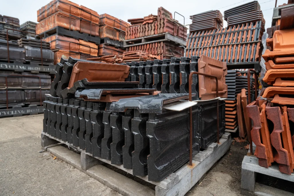 Stacked reclaimed terracotta roof tiles in storage